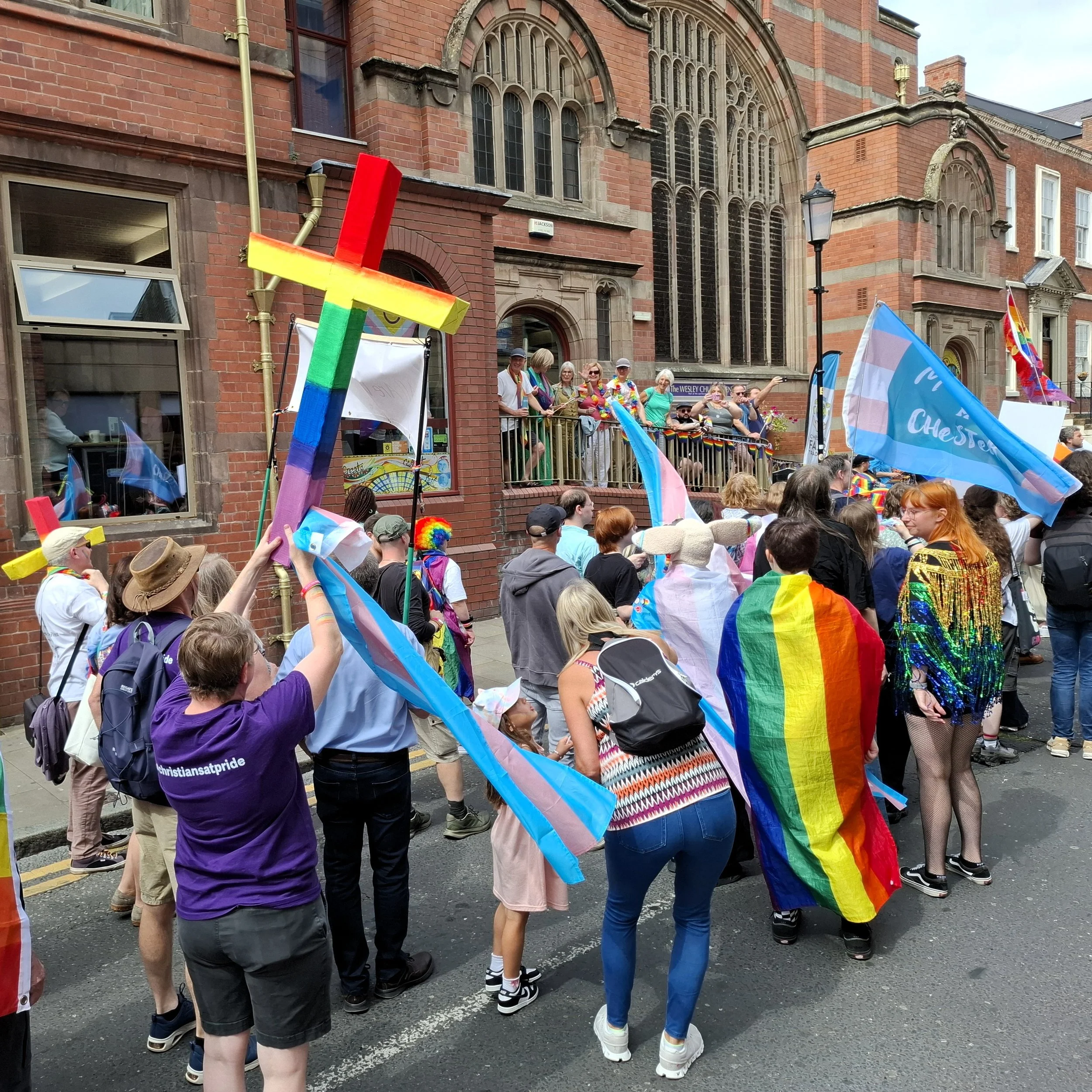 The torn Pride Progress flag bunting on the table at the back of church.