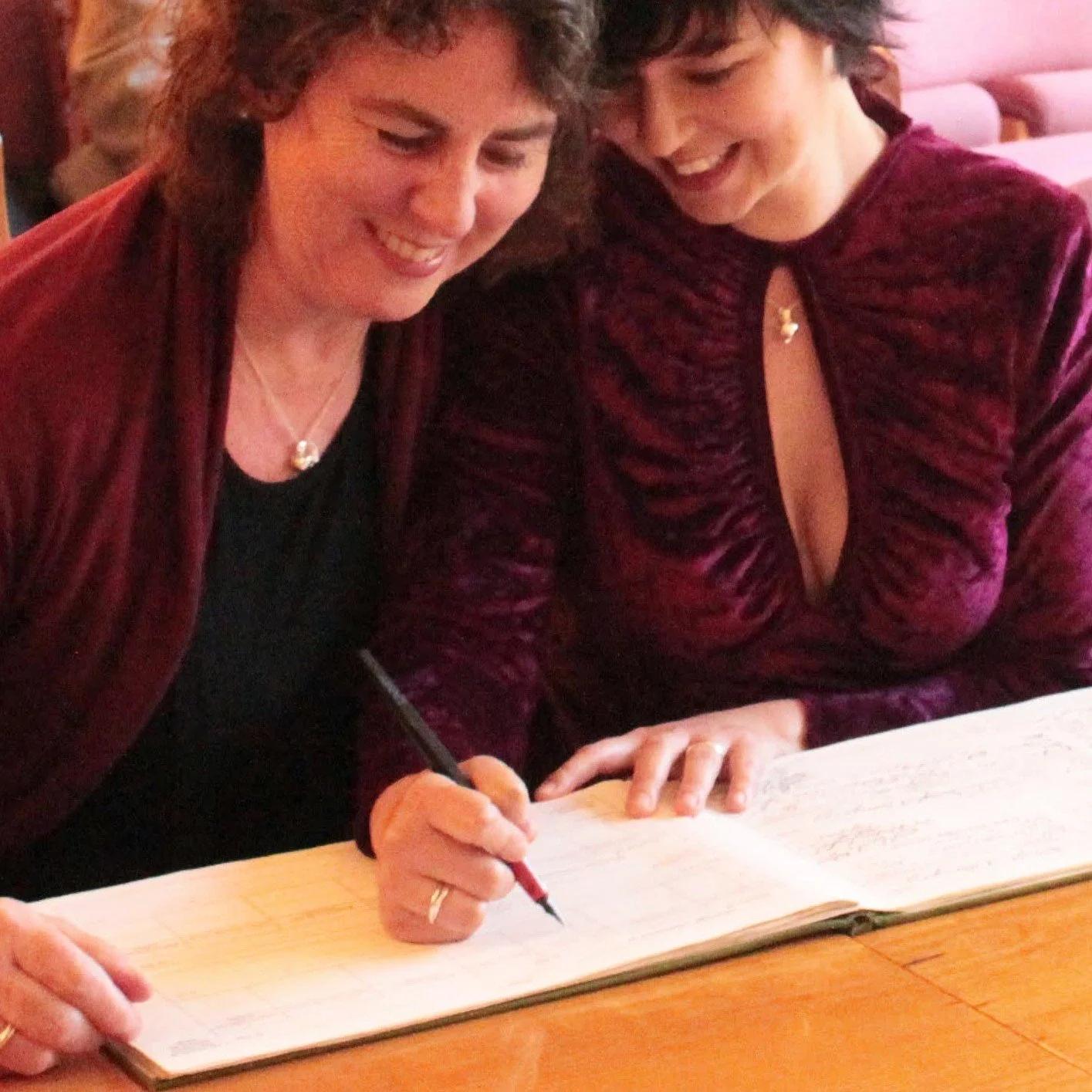 Wendy and her wife Jo signing the register at their wedding in 2014.